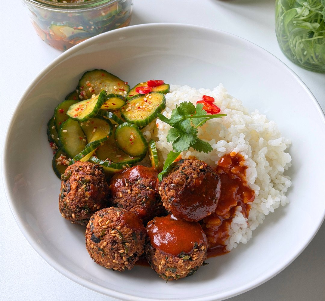 A white plate topped with falafel and rice.