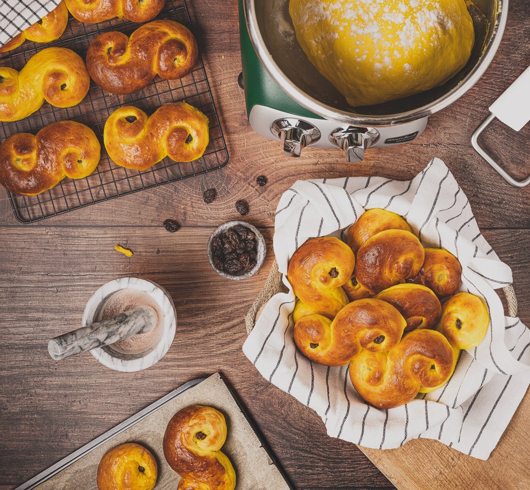A bunch of saffron buns that are on a table.