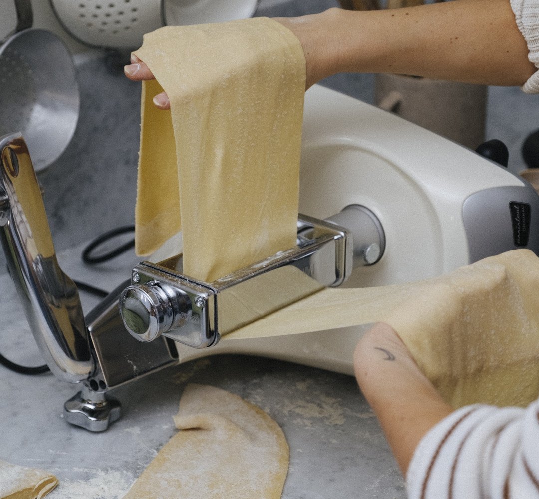 A person that is making homemade pasta in a kitchen.