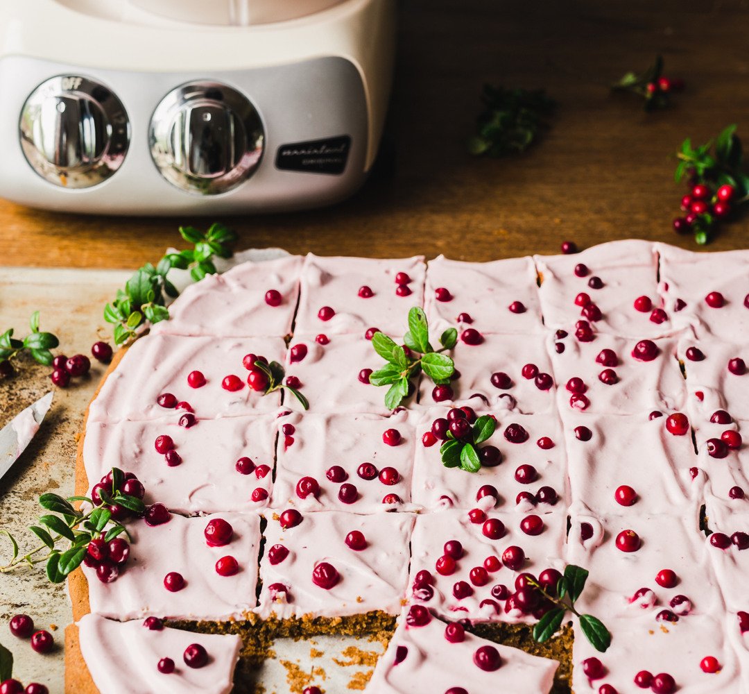 Gingerbread sheet cake on baking paper on a wooden countertop.