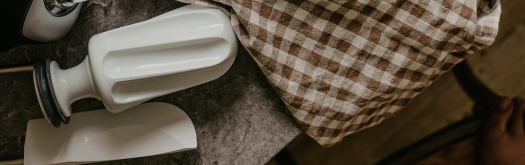 A wooden cutting board topped with lots of bread.