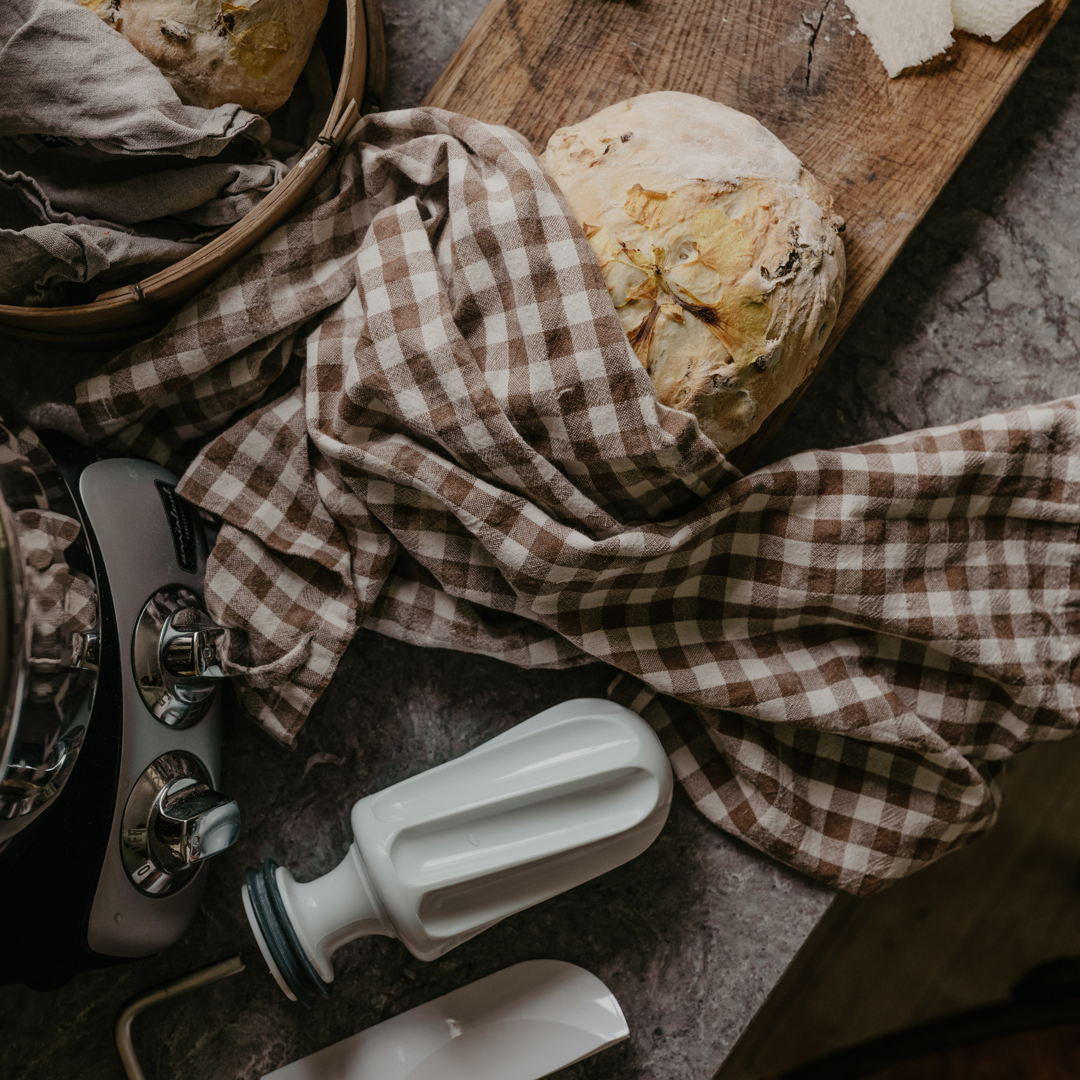 A wooden cutting board topped with lots of bread.