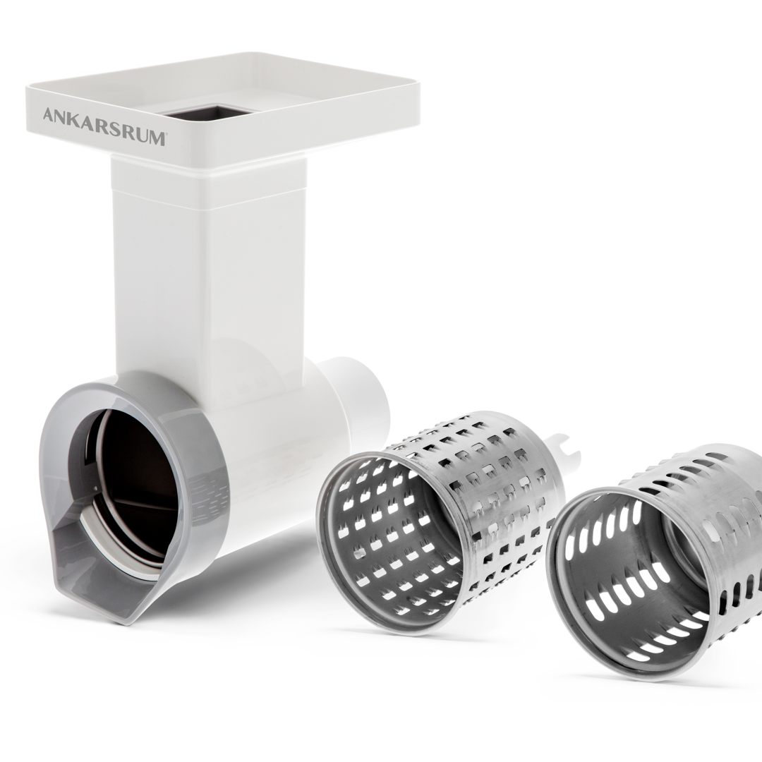 A vegetable cutter and a pair of drums on white background.