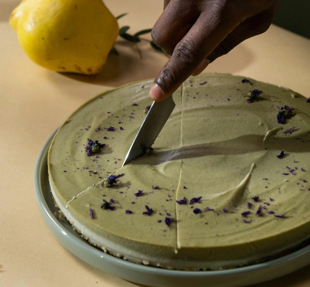 En person som skär en cheesecake med en kniv.