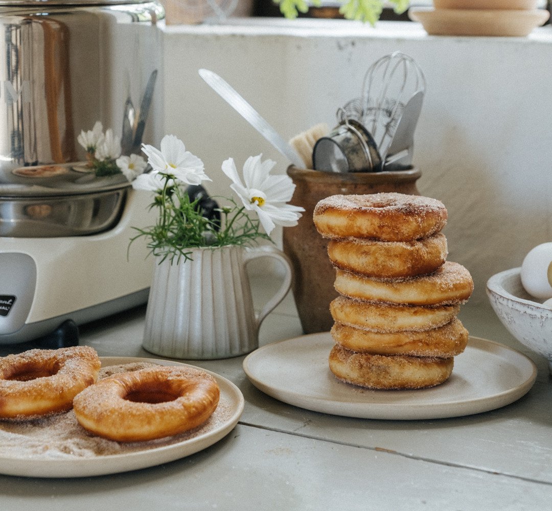 A stack of doughnuts sitting on top of a table.