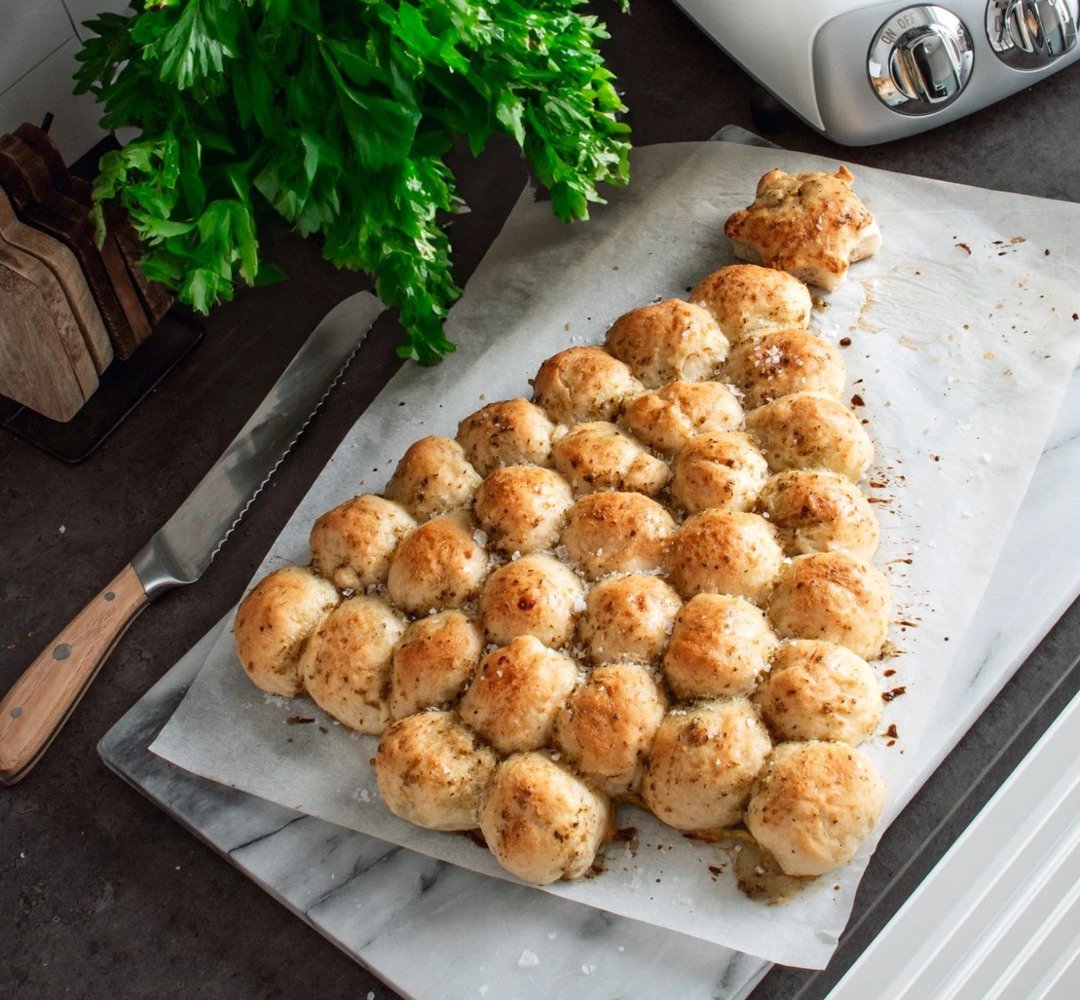 A table topped with mozzarella and pesto bread.