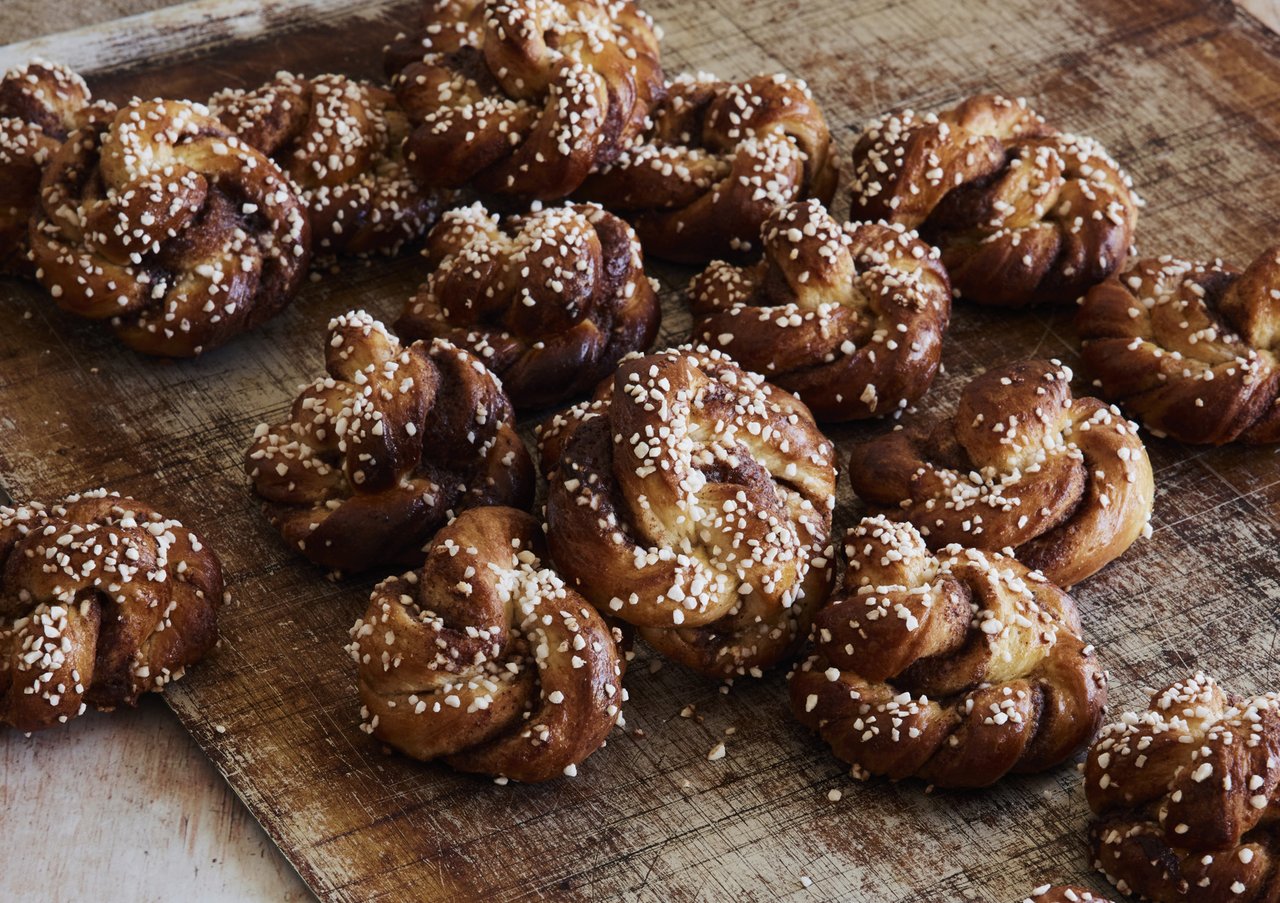 En träskärbräda toppad med nybakade kanelbullar