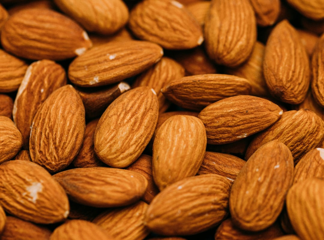 A pile of almonds sitting on top of each other.