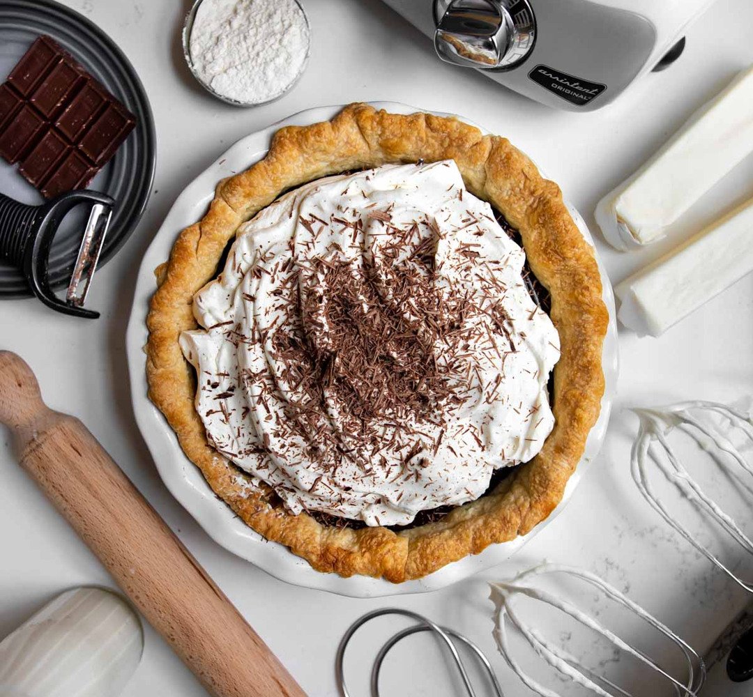 A pie sitting on top of a white table.