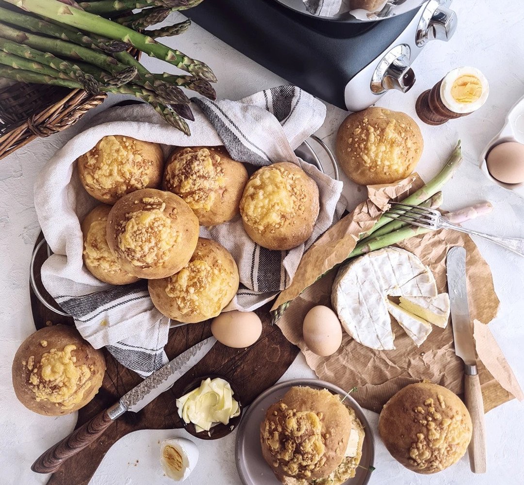 A bunch of cheese bread that is on a table.