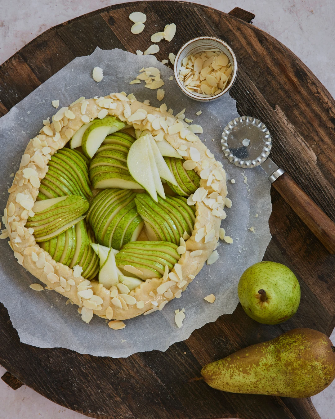 Delicious homemade pear pie with a golden crust, prepared using an Ankarsrum stand mixer for the perfect pastry consistency.