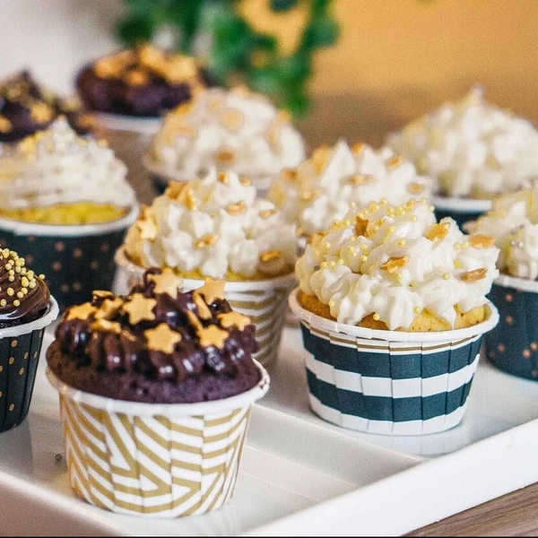 A tray of freshly baked homemade Saffron Cupcakes with Nutella Icing and sprinkles