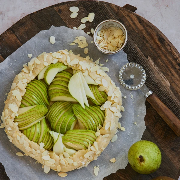 Delicious homemade pear pie with a golden crust, prepared using an Ankarsrum stand mixer for the perfect pastry consistency.
