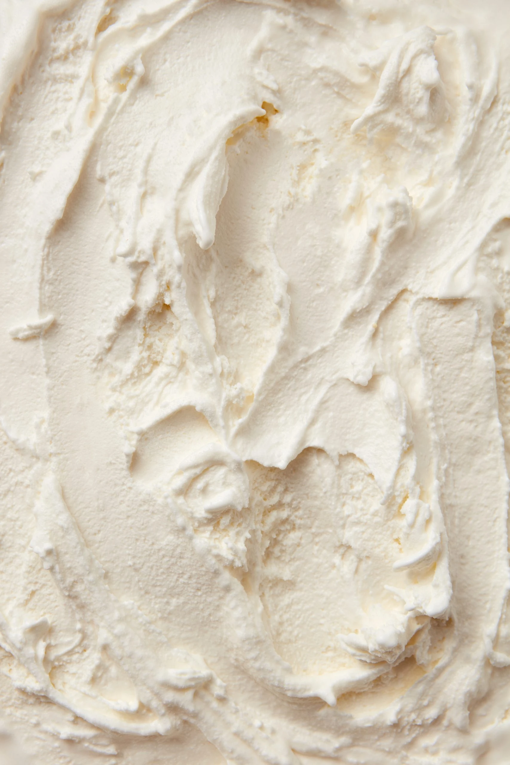 Close-up of smooth, creamy white whipped cream or frosting with swirled texture, made with Ankarsrum stand mixer.