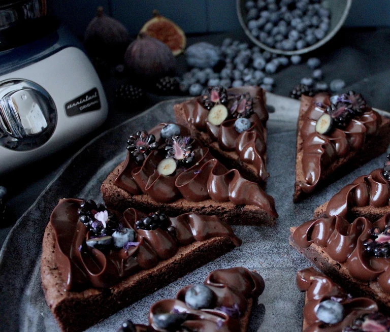 Chocolate brownie slices topped with ganache, blueberries, blackberries & figs, made with Ankarsrum Original stand mixer.
