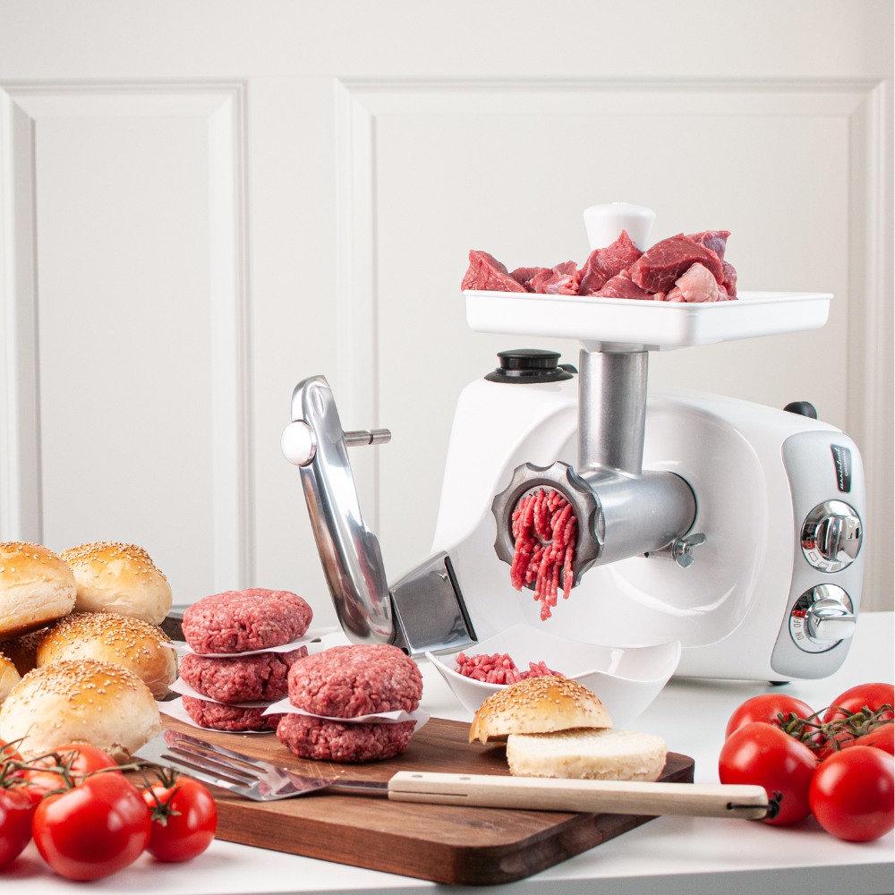 Meat grinder attachment for Ankarsrum stand mixer grinding meat for burgers on kitchen counter